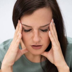Young Woman Holding Head While Suffering From Headache Young Woman Holding Head While Suffering From Headache